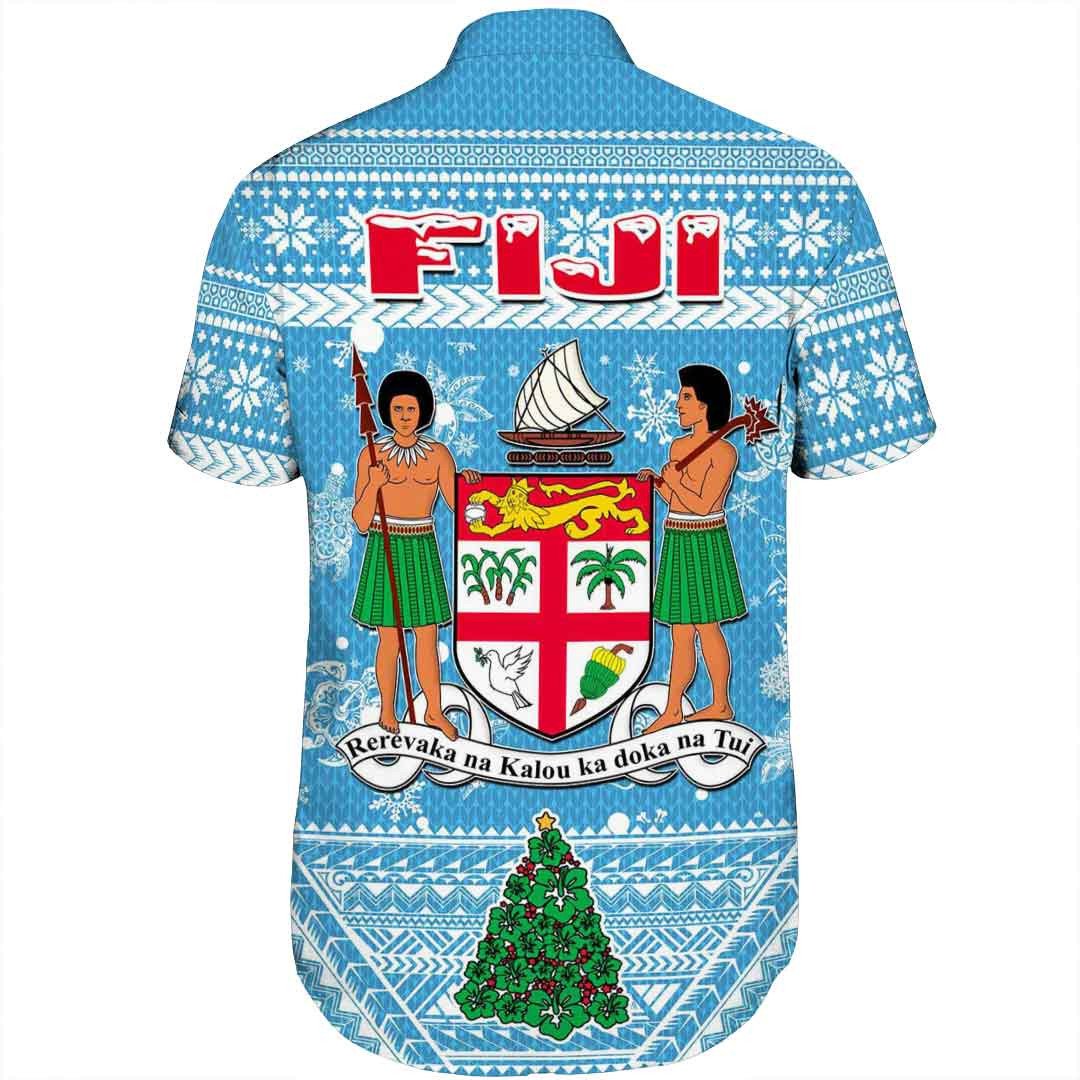 Short-sleeve button shirt, blue back view with crest, figures, and snowflake bands.