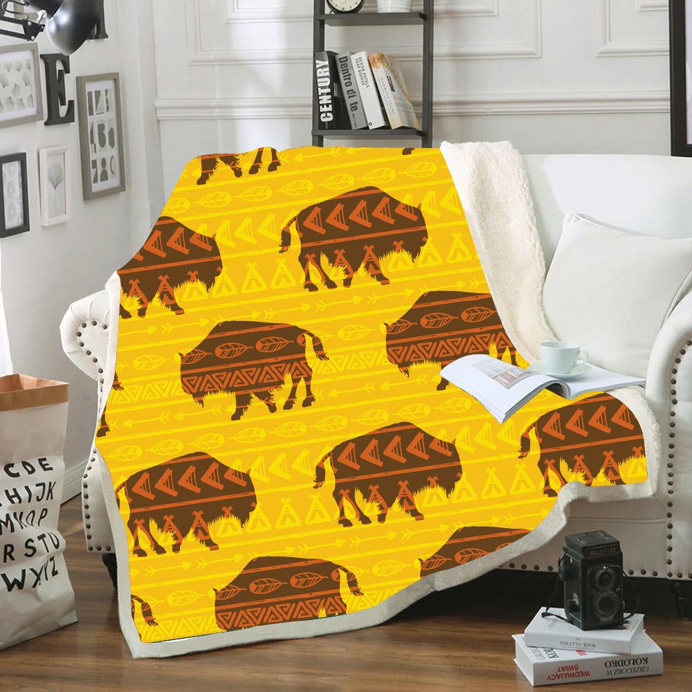 Yellow blanket with repeating bison and tribal arrow pattern