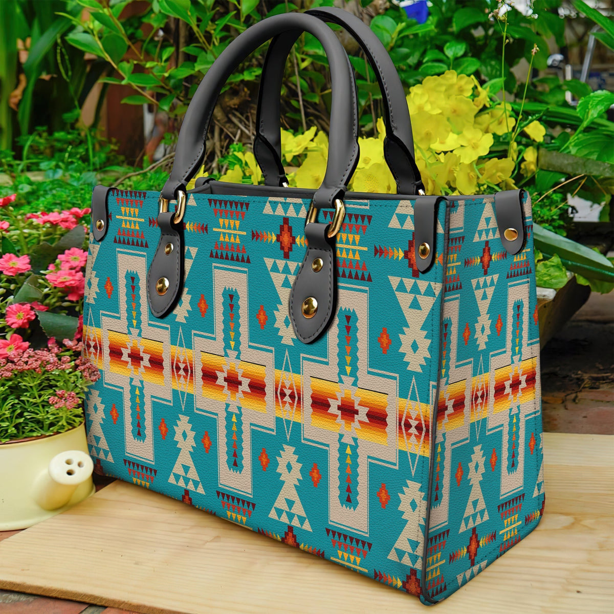 Geometric turquoise multicolor leather tote bag with black double handles and brass studs