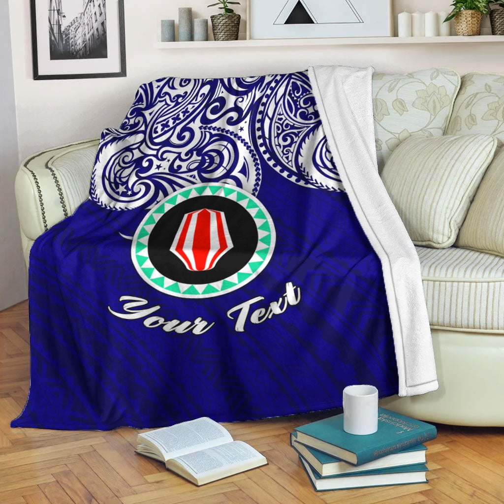Blue blanket with white-and-blue ornate pattern, central emblem and “Your Text”.