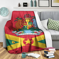 Grenada flag blanket draped on couch, showing coat of arms, cross, and star