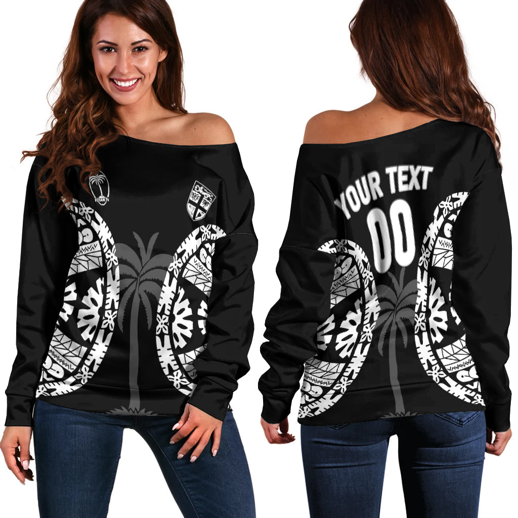 Women’s off-shoulder sweater in black with white tapa pattern and crest print