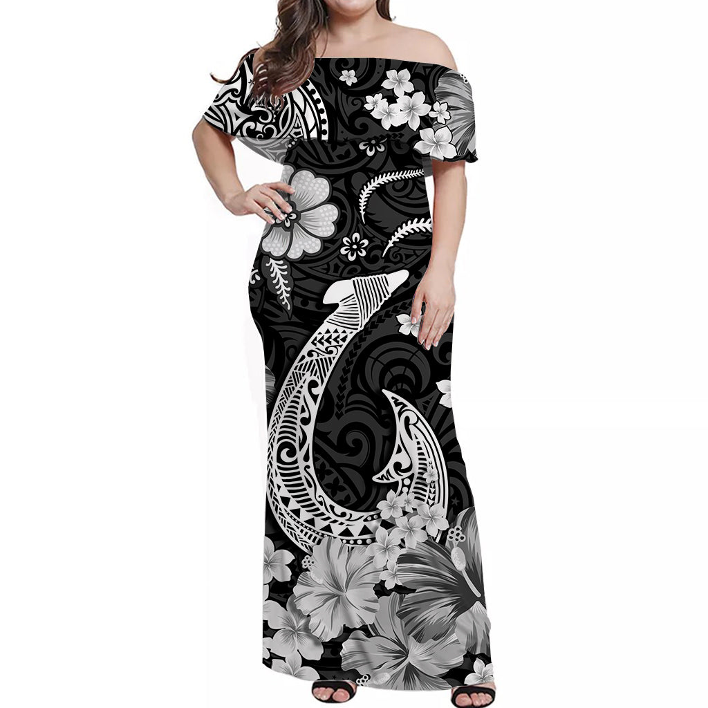 Black off-shoulder maxi Hawaiian dress with white hibiscus, leaves, and fish-hook motifs
