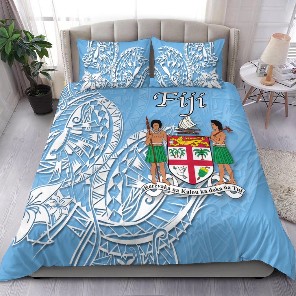 Fiji bedding set in blue with white tribal waves and center coat-of-arms design