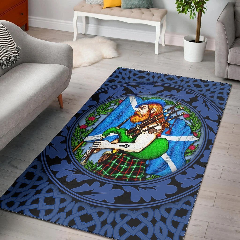 Blue area rug with Highlander holding bagpipes, oval portrait, Celtic knot border