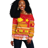 Red off-shoulder sweater with Tigray-style Christmas African pattern, front view