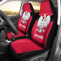 Red car seat covers with black edges, white eagle crest and 'POLAND' text on front panels