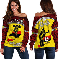 Women’s off-shoulder sweater back view: People Power text and fist graphic in red and yellow