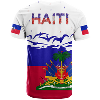 White T-shirt back with bold HAITI text, small figures, and flag sleeve panels
