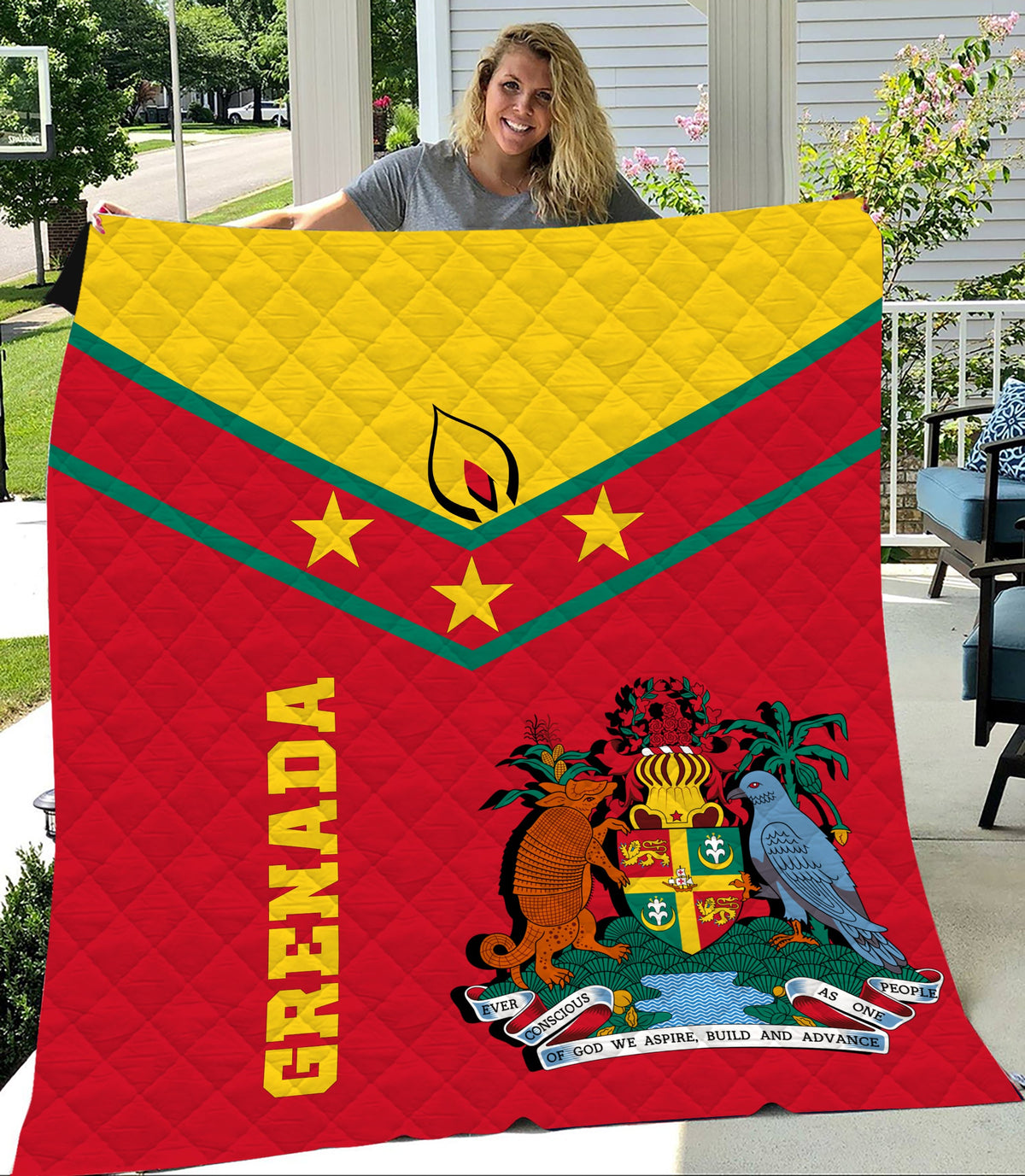 Red quilt with yellow top band, green stripes, Grenada crest and text, diamond quilting.