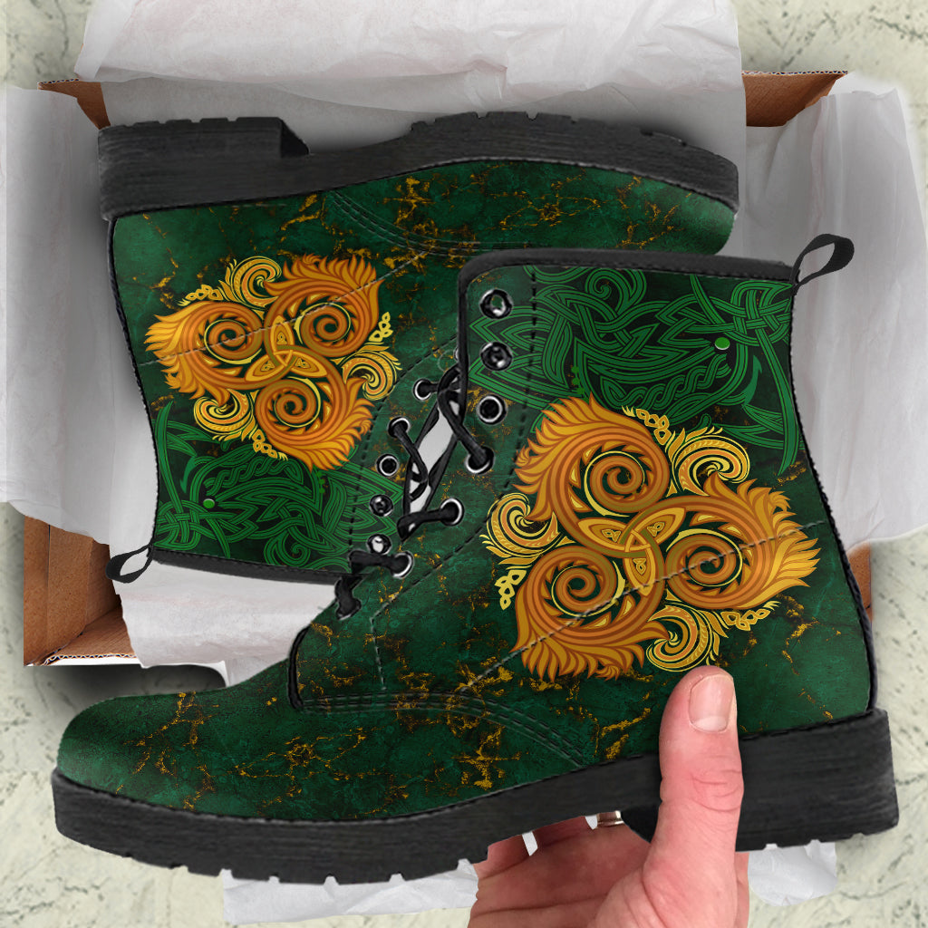Green leather lace-up boots with Celtic triple spiral print, black sole, scuffed toe