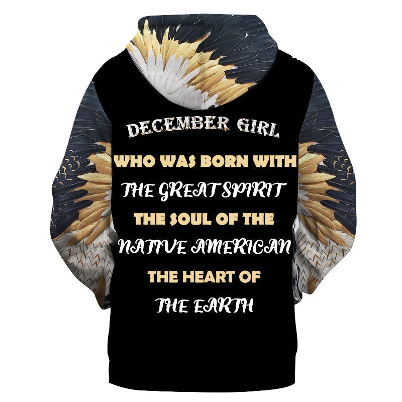 Girls pullover hoodie, dark base with “DECEMBER GIRL” feather graphic and multicolor text