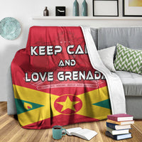 Multicolor Grenada-themed throw blanket on a sofa with “KEEP CALM AND LOVE GRENADA” text