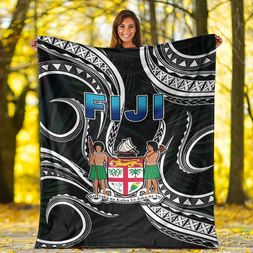 Black Fiji blanket with Polynesian swirl patterns, white arches, blue “FIJI” and crest