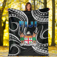 Black Fiji blanket with Polynesian swirl patterns, white arches, blue “FIJI” and crest