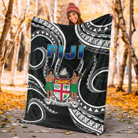 Black Fiji blanket with tribal waves and white arches, blue “FIJI” over coat of arms