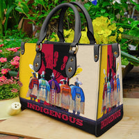 Multicolor leather tote side view with Native-style figures print, studded handles, “INDIGENOUS”