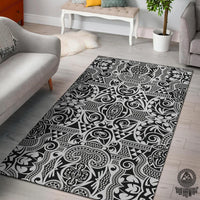 Black-and-white Polynesian area rug with bold swirling and tribal pattern, rectangular shape