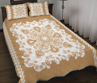 Gold bedspread quilt with large white floral medallion, matching pillows with diamond trim