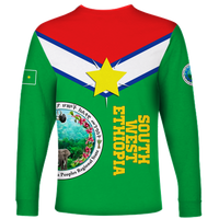Green unisex long-sleeve shirt with large circular emblem, star, and vertical text