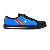 Low-top sneaker side view, blue with red/yellow stripe and yellow star, black laces and sole