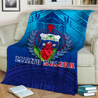 Blue Manu Samoa blanket with crest and laurel, “MANU SAMOA” title across the front