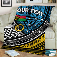 Personalized blue blanket with shield graphic, stars, and tribal stripes over sofa