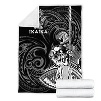 Black blanket with Ikaika warrior artwork and IKAIKA text, folded with soft white backing