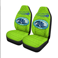 Two green seat covers with NAPU Outrigger logo on headrests and cushions