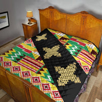 Kente quilt draped on bed: black center band with gold cross ornaments