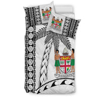 White bedding set with black tapa border, palm fronds, and island crest with figures