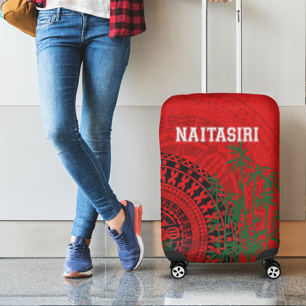 Red suitcase cover with tapa design and NAITASIRI text, wheels and handle openings