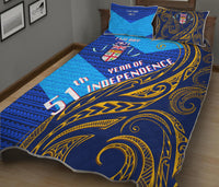 Blue quilt and pillow set with large gold scroll pattern and red independence text