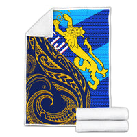 Folded blue and gold Polynesian blanket set with yellow figure; includes rolled towels