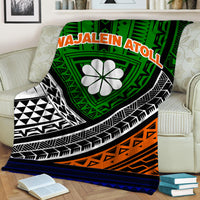 Tribal blanket with green center, black geometric stripes, orange panel, and white flower emblem