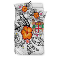 White bedding set with twin pillows showing Fiji tribal black print and orange hibiscus