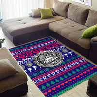 Blue area rug with central black-and-white emblem and red-green striped holiday bands