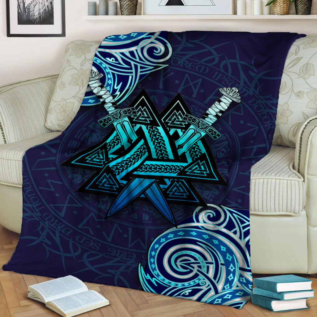 Dark blue Viking Valknut blanket with teal star design and circular emblem, shown folded over couch