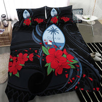 Black bedding set close view: red hibiscus florals and blue Guam graphic on duvet
