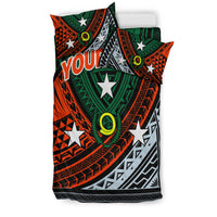 Green duvet and matching pillowcases with orange tribal patterns, stars, and 'YOUR TEXT'
