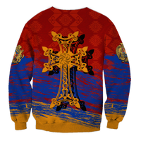 Red crewneck sweatshirt with gold cross ornament and blue patterned bottom