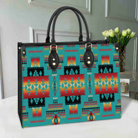 Black leather handles and gold studs on multicolor Native-pattern tote bag