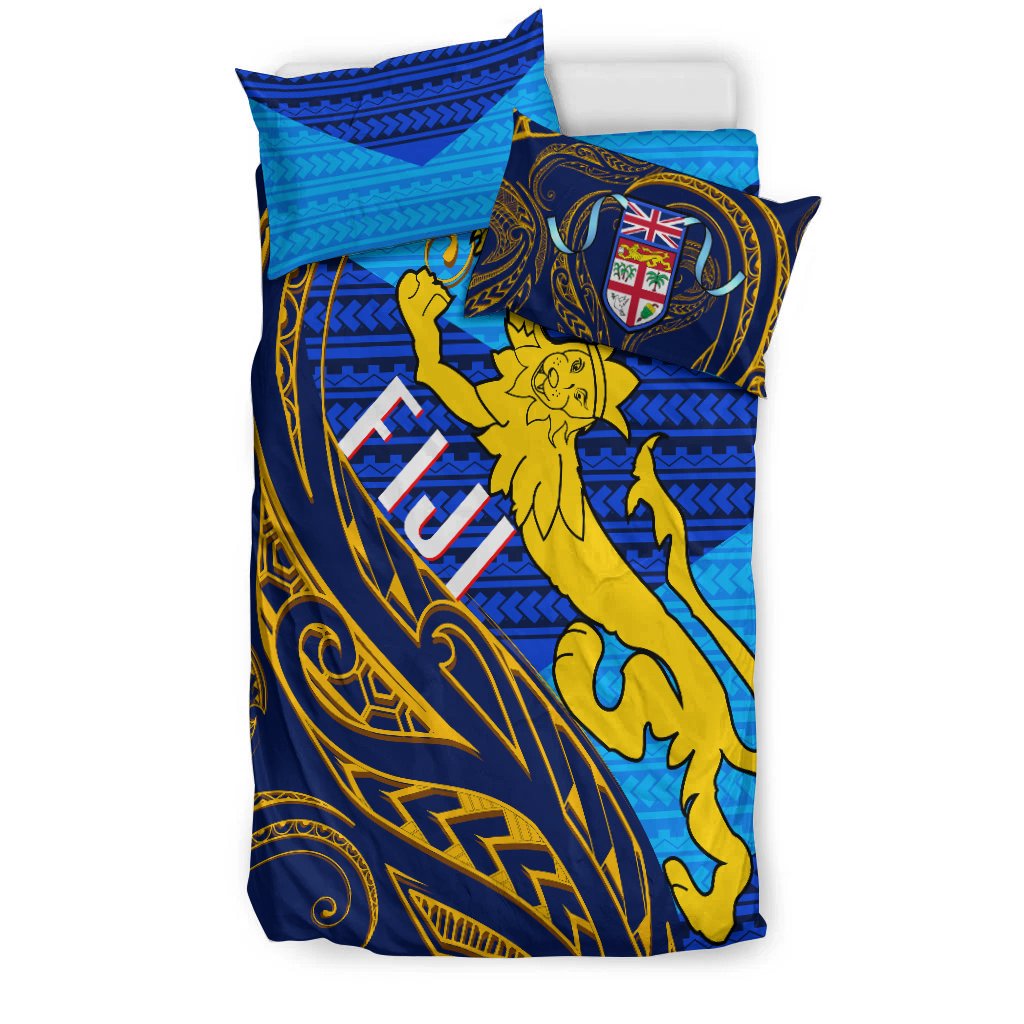 Blue duvet and pillowcases with gold curving Polynesian design, crest shield and dancer