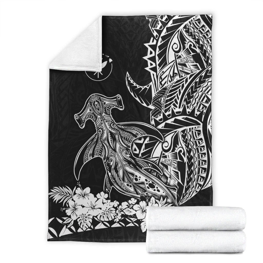 Black hammerhead shark blanket with tribal sail design, folded with white reverse side