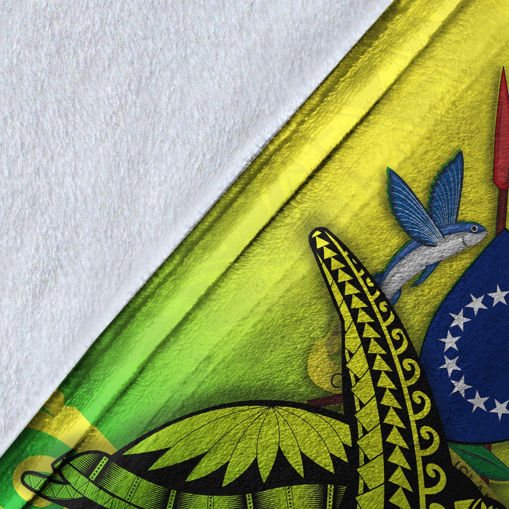 Green blanket close-up with woven-style pattern and partial bird graphic