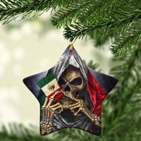Star-shaped ceramic ornament close-up showing skull with red green cloak, gold hanging loop