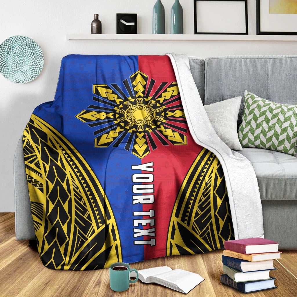 Premium blanket on sofa with blue, red, and gold sun rays and vertical “YOUR TEXT”