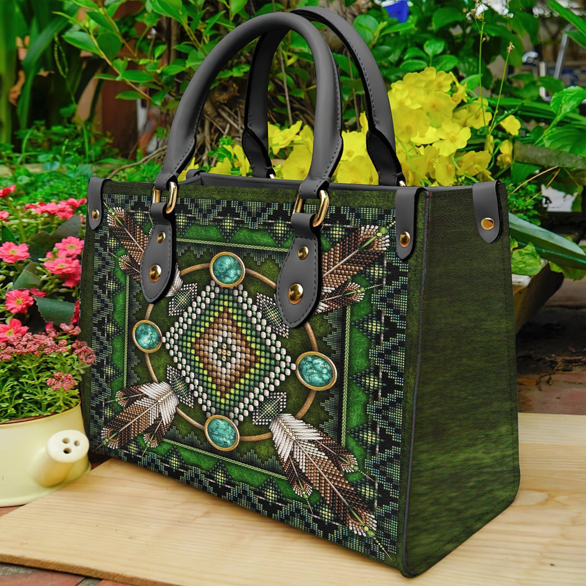 Green leather tote with beaded feather design, front snap pockets and black strap handles