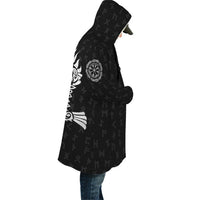 Black hooded cloak draped on model, side view with white raven tail graphic