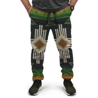 Native-style jogger pants, black base with green bands and beige geometric diamond print